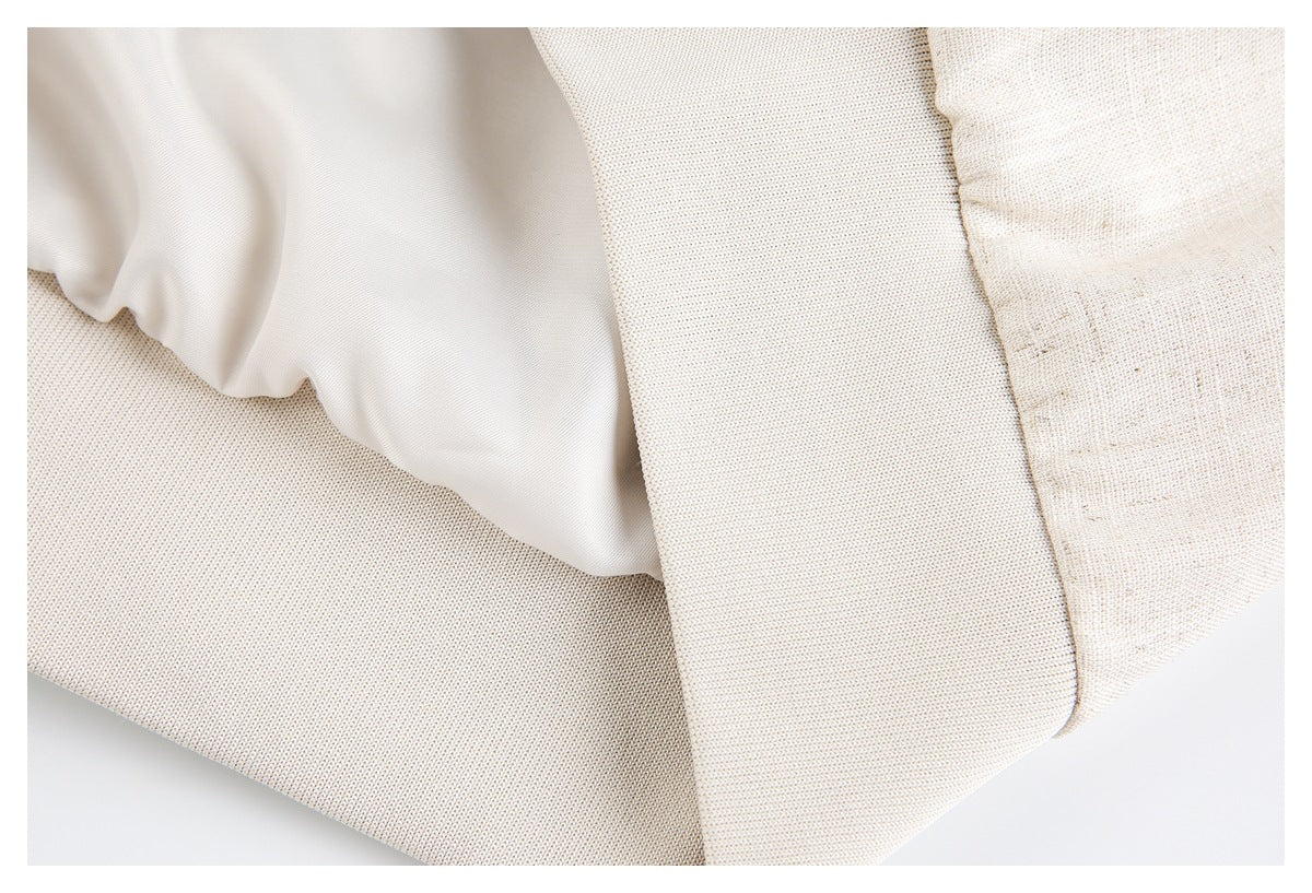 Close-up of the cream jacket's interior lining and layered fabric construction.