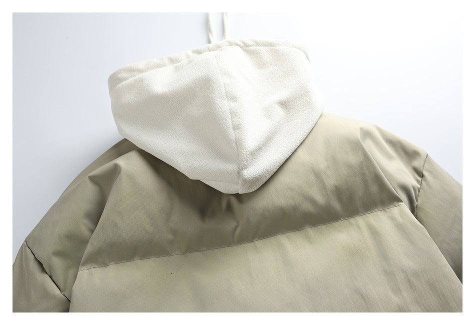 Close-up of the jacket's back shoulder and cream hood, with contrasting taupe panels.
