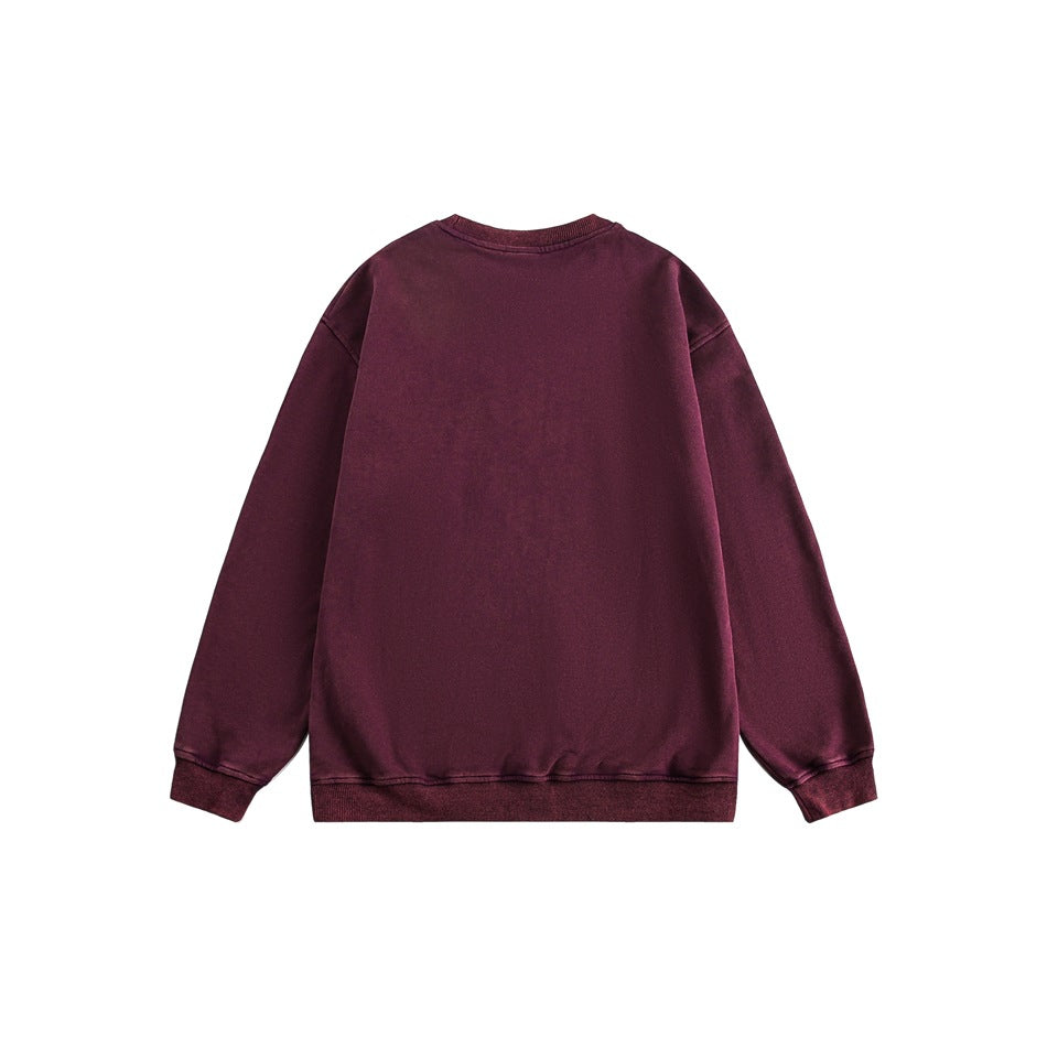 Back view of a plain burgundy long-sleeve crewneck sweatshirt with ribbed cuffs and hem.