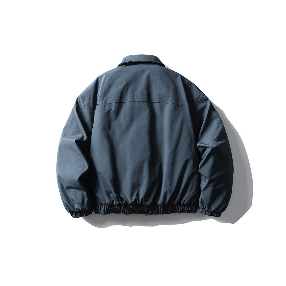 Back view of gray-blue padded jacket with back yoke seam, pointed collar and elastic cuffs and hem