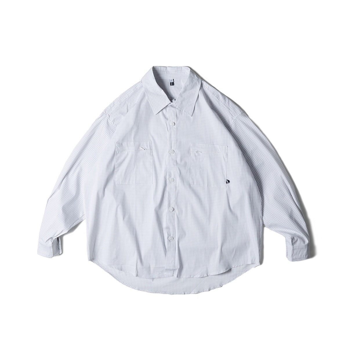 White long-sleeve button-front shirt with fine light blue grid check and two chest pockets, flat lay