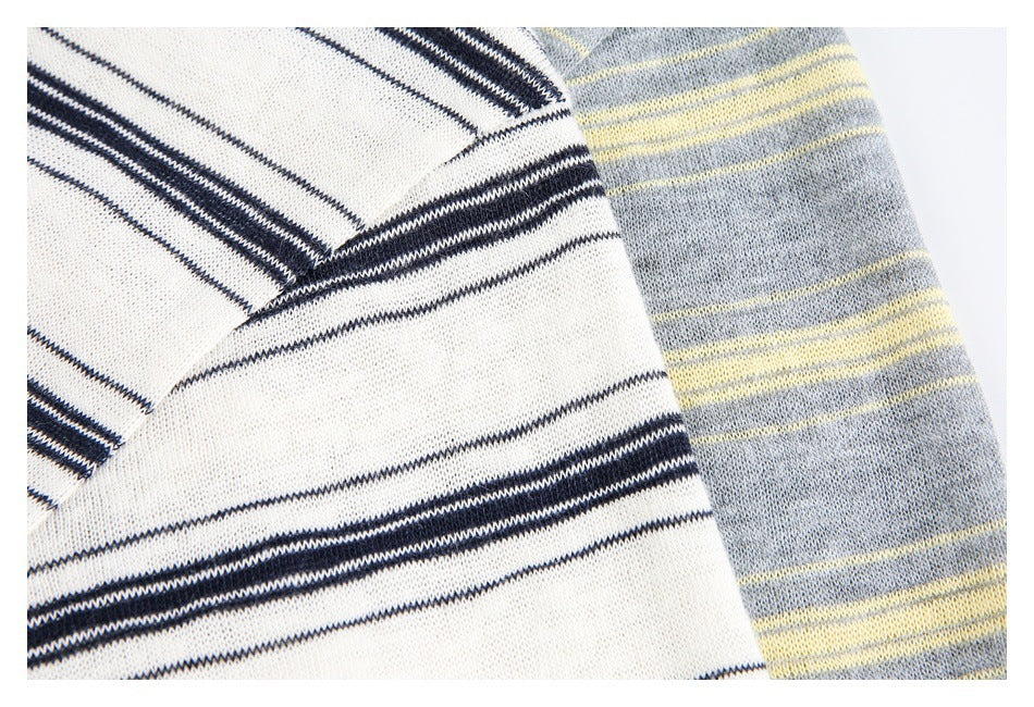 Close-up of ivory and navy stripes beside gray and pale yellow stripes on polo fabric.
