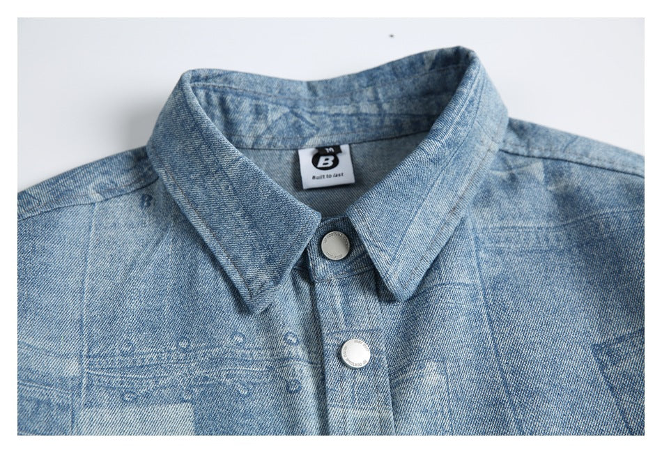 Close-up of the light blue shirt's pointed collar and upper front with silver snap buttons.