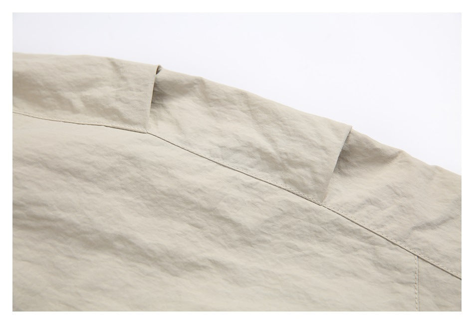 Close-up of stitched panel seams on the back of light beige pants.