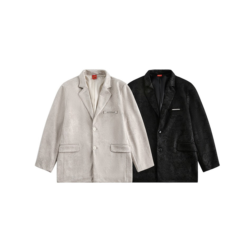 Two front-view blazers, one light beige and one black, with a subtle allover pattern and lapels.