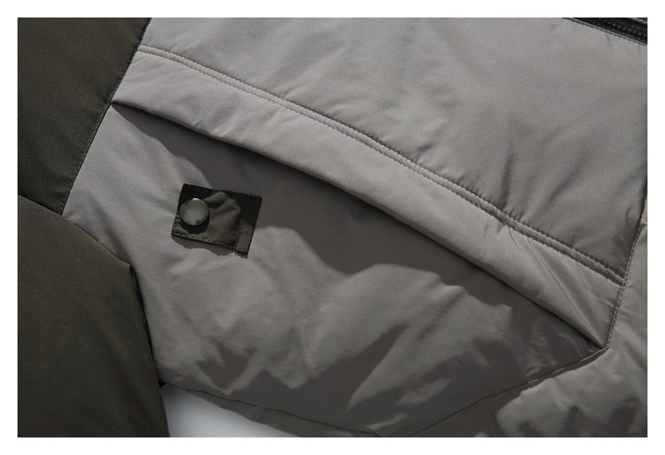 Close-up of a gray jacket panel with a stitched flap and dark snap fastener.
