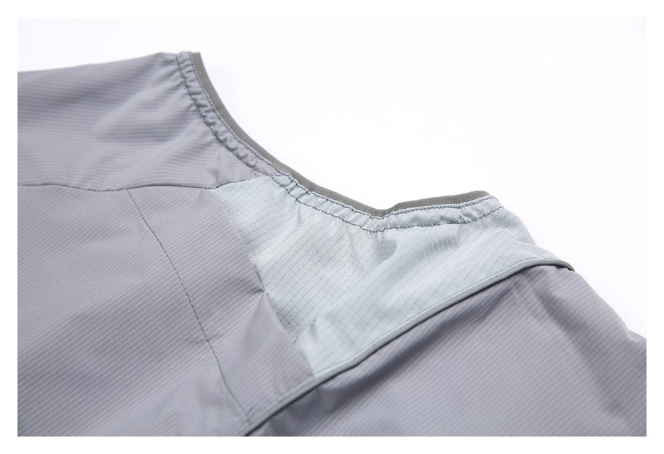 Close-up of the vest shoulder and armhole, showing a pale contrasting panel with a subtle grid pattern.