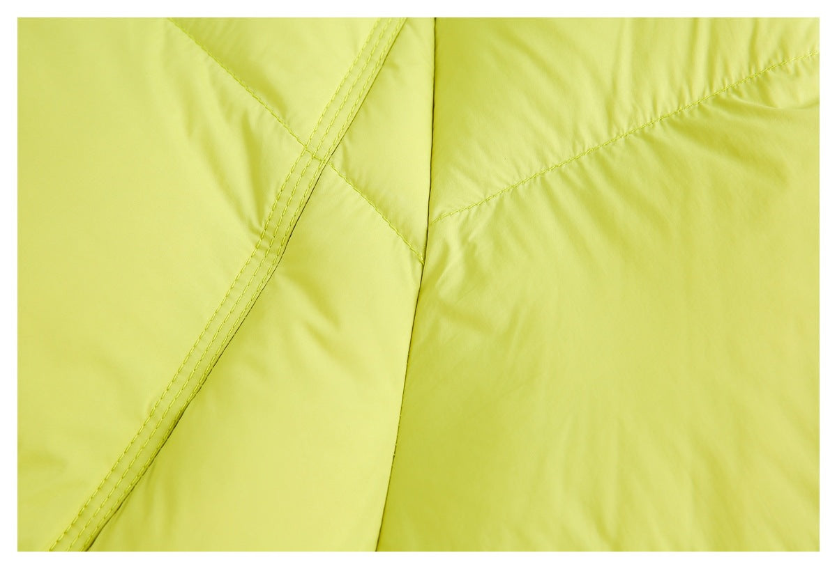 Close-up of lime-green jacket panels and intersecting stitched seams.