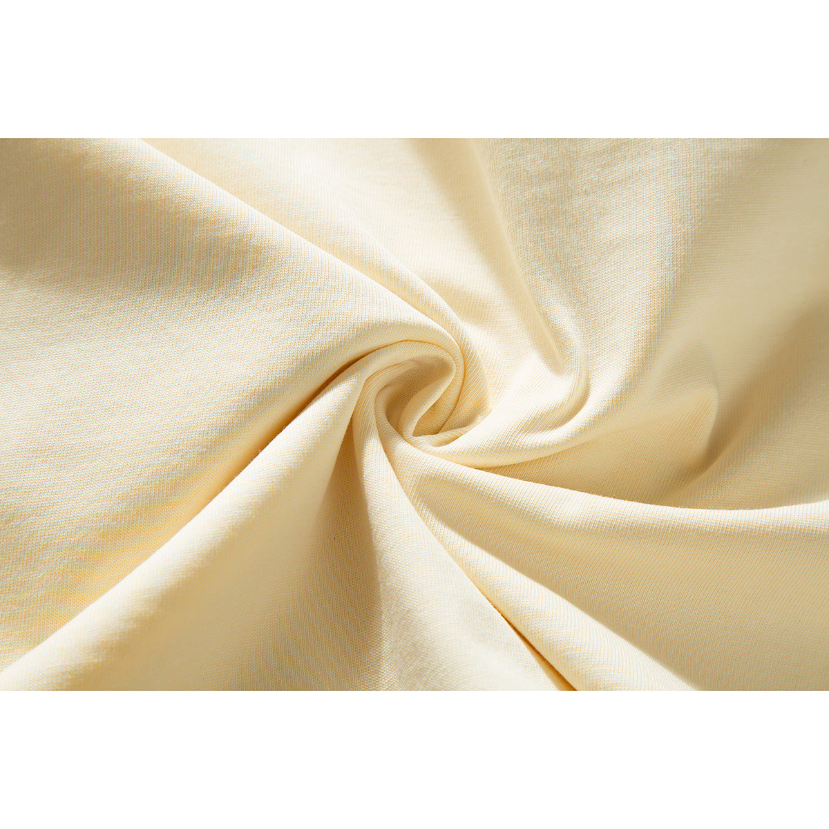 Close-up of ivory fabric gathered into a swirl, showing its surface and texture.
