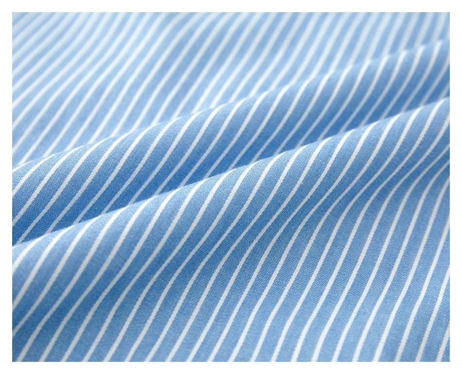 Close-up of the blue-and-white striped shirt fabric gathered into soft folds.