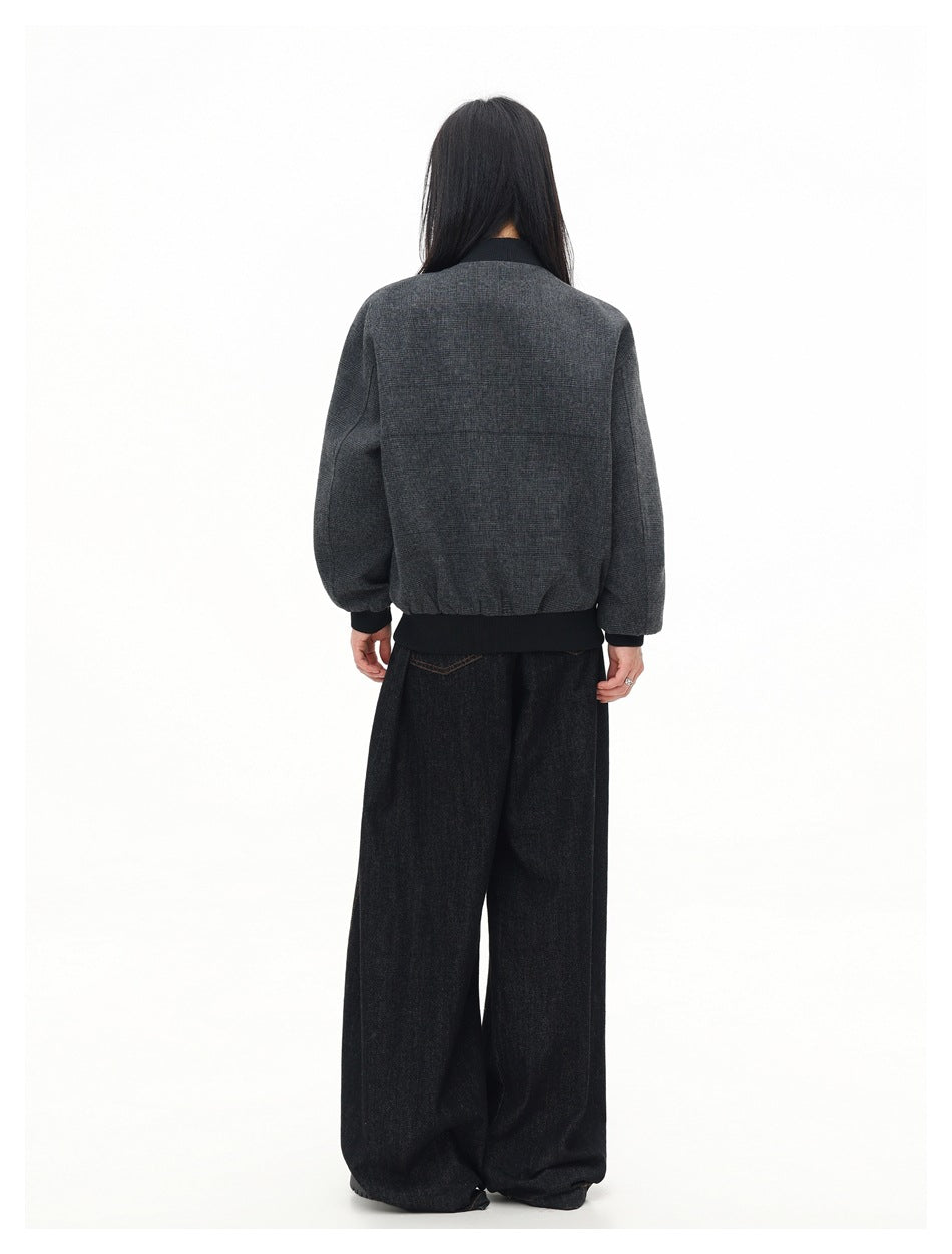 Back view of a model wearing a charcoal gray plaid bomber jacket with black ribbed collar, cuffs, and hem.