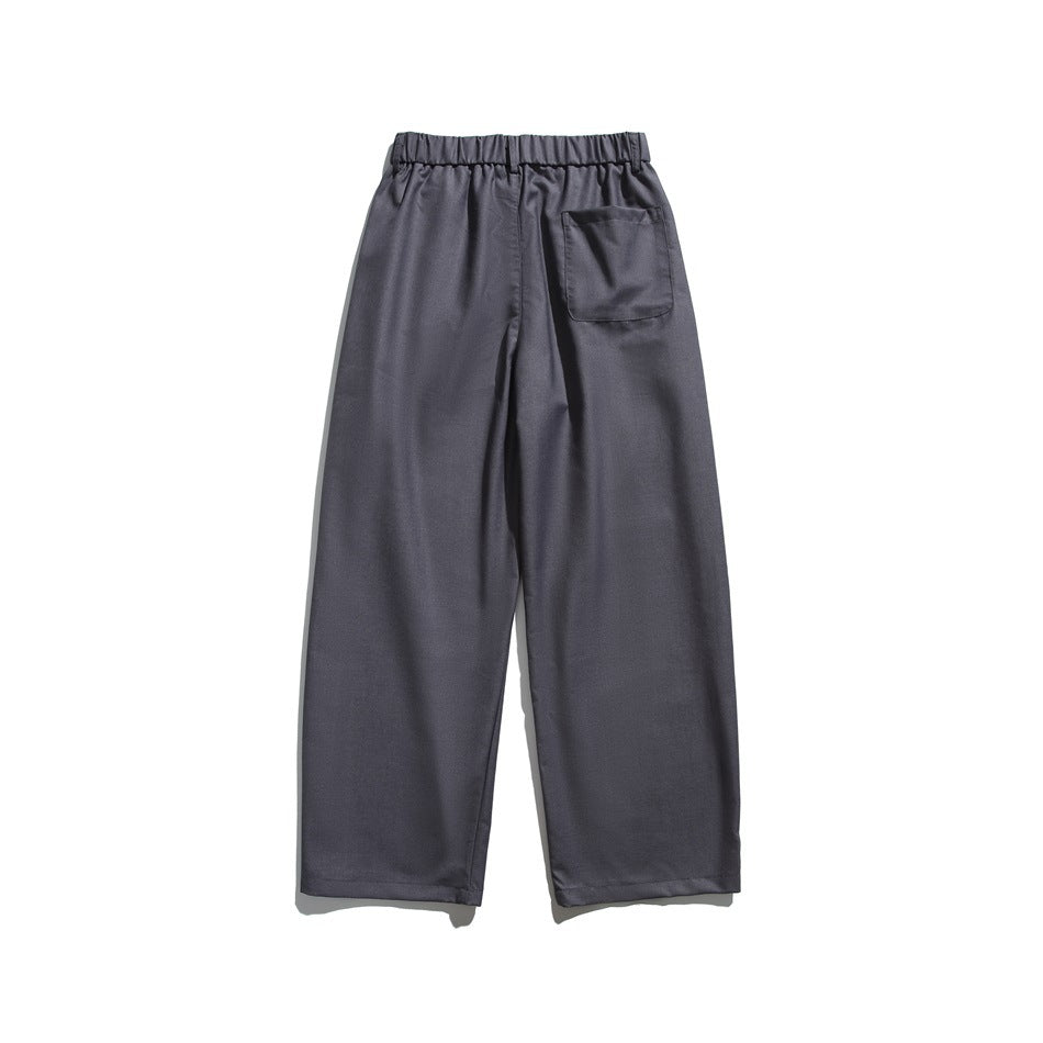 Back view of charcoal-gray trousers with an elastic waistband and a single patch pocket.