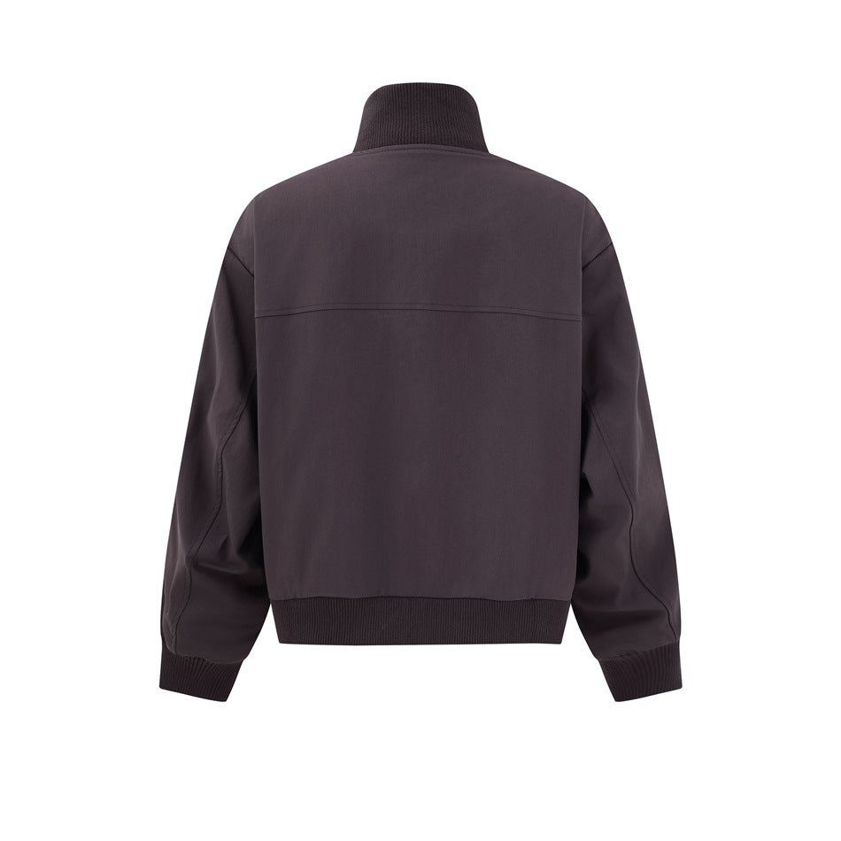 Back view of a dark charcoal jacket with a ribbed stand collar, cuffs and hem and a horizontal shoulder seam.