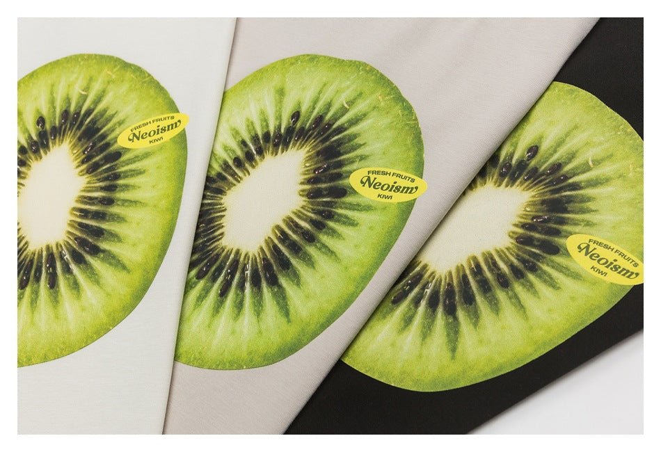 Three T-shirt colorways—white, beige, and black—with a large kiwi slice graphic and small English print.