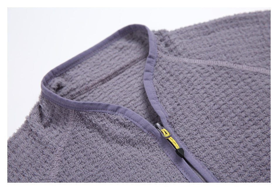 Close-up of the jacket's stand collar, purple binding, and yellow main zipper pull.