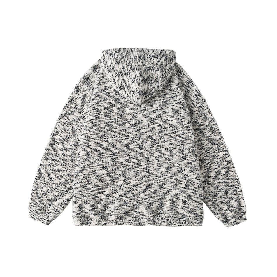 Back view of a hooded jacket in a black-and-white textured pattern.