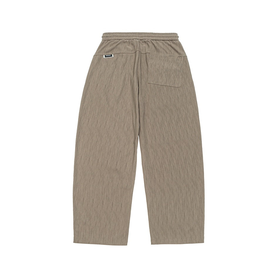 Back view of taupe-gray wide-leg pants with an elastic waistband and rear pockets, shown flat on white.