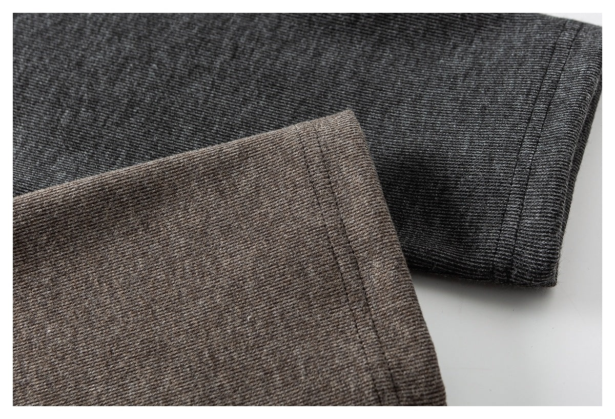 Close-up of charcoal and taupe heathered knit sleeves with stitched cuffs.