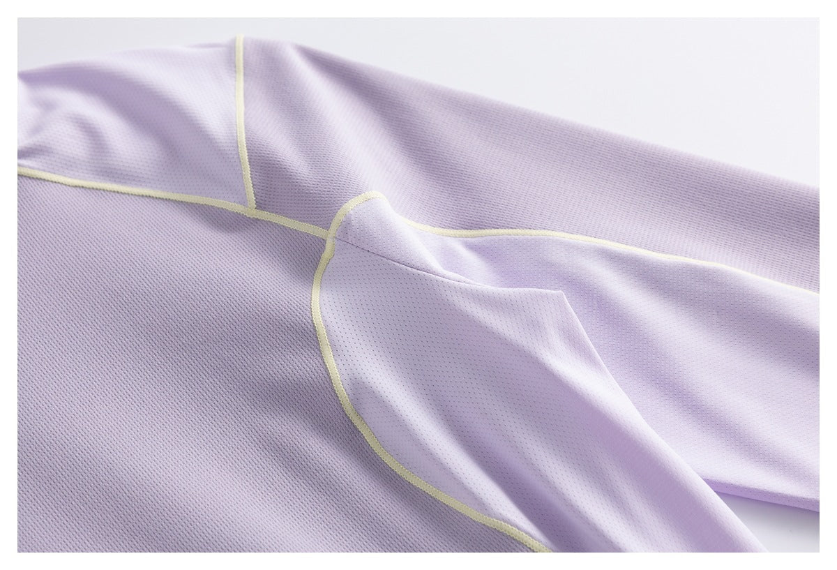 Close-up of the lavender garment's mesh fabric and curved panel seams with pale yellow piping.