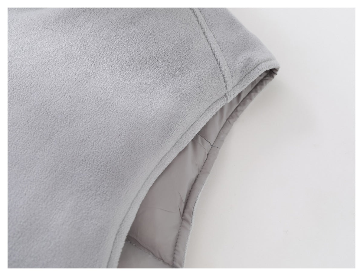 Close-up of the light gray jacket's fleece outer layer and smooth inner lining at a seam.