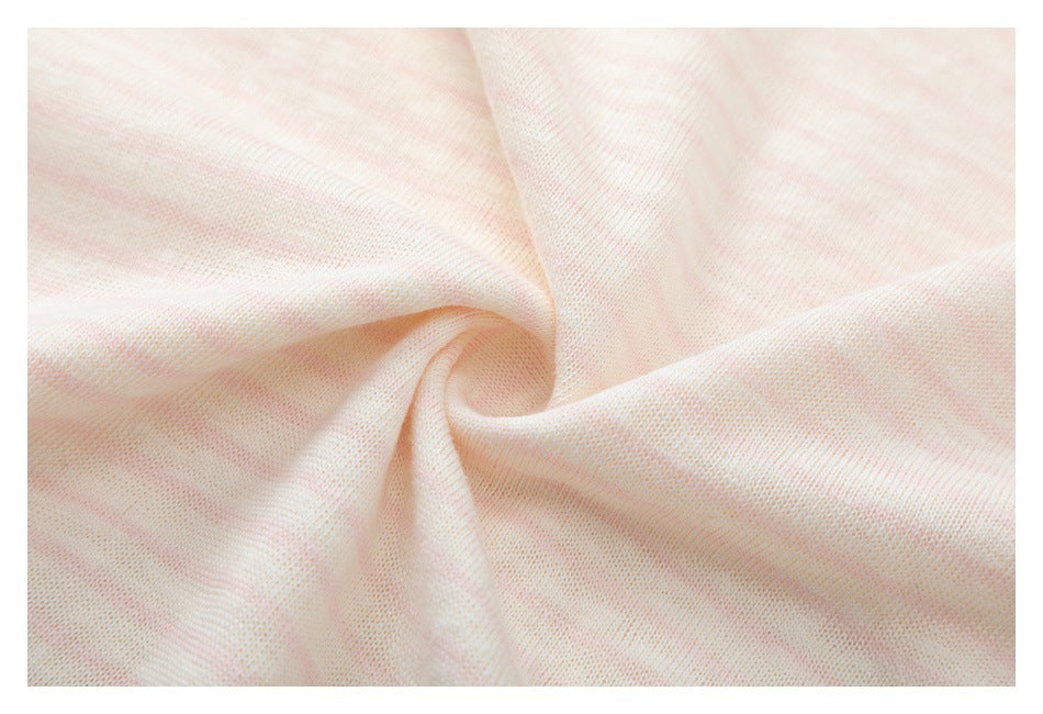 Close-up of pale pink and cream striped knit fabric gathered into a soft swirl.