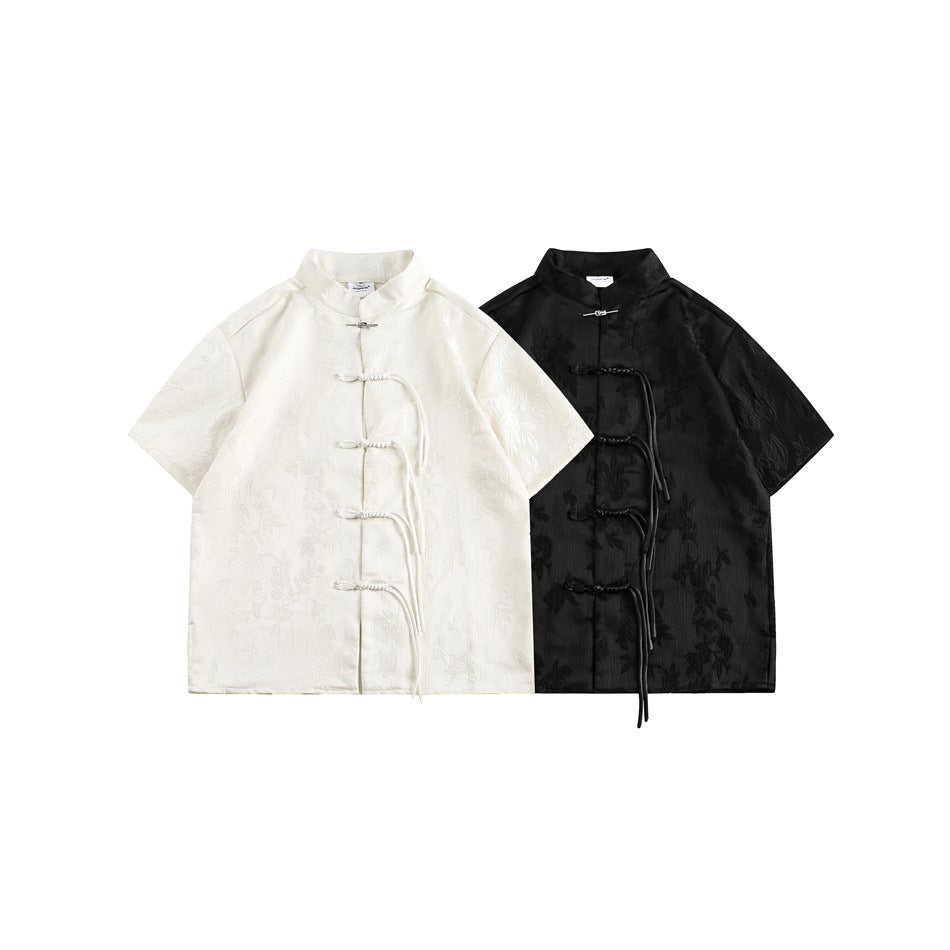 Ivory and black short-sleeve shirts with stand collars, floral patterns, and braided front closures, shown flat.
