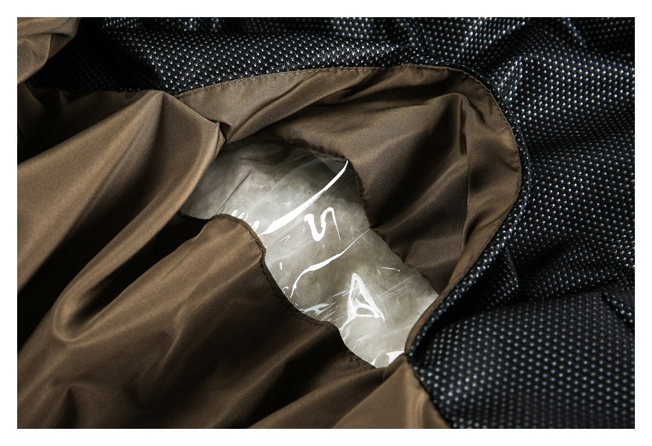 Close-up of brown garment lining and black dotted fabric around a clear plastic insert.