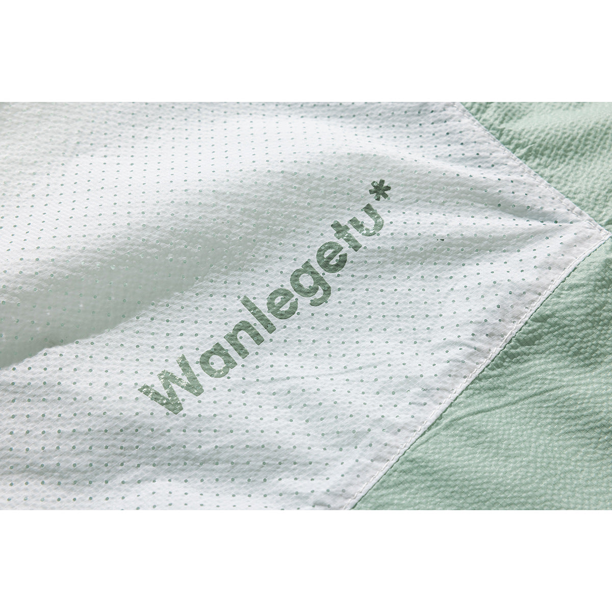 Close-up of the jacket's pale dotted lining with a printed wordmark.