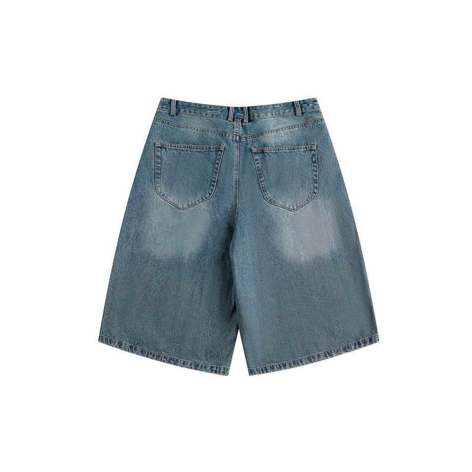 Back view of faded blue denim shorts showing two patch pockets and lighter worn-in patches