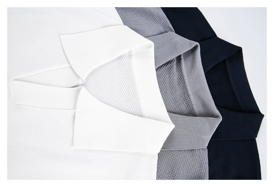 Close-up of white, gray, and navy polo collars and textured fabric arranged together.