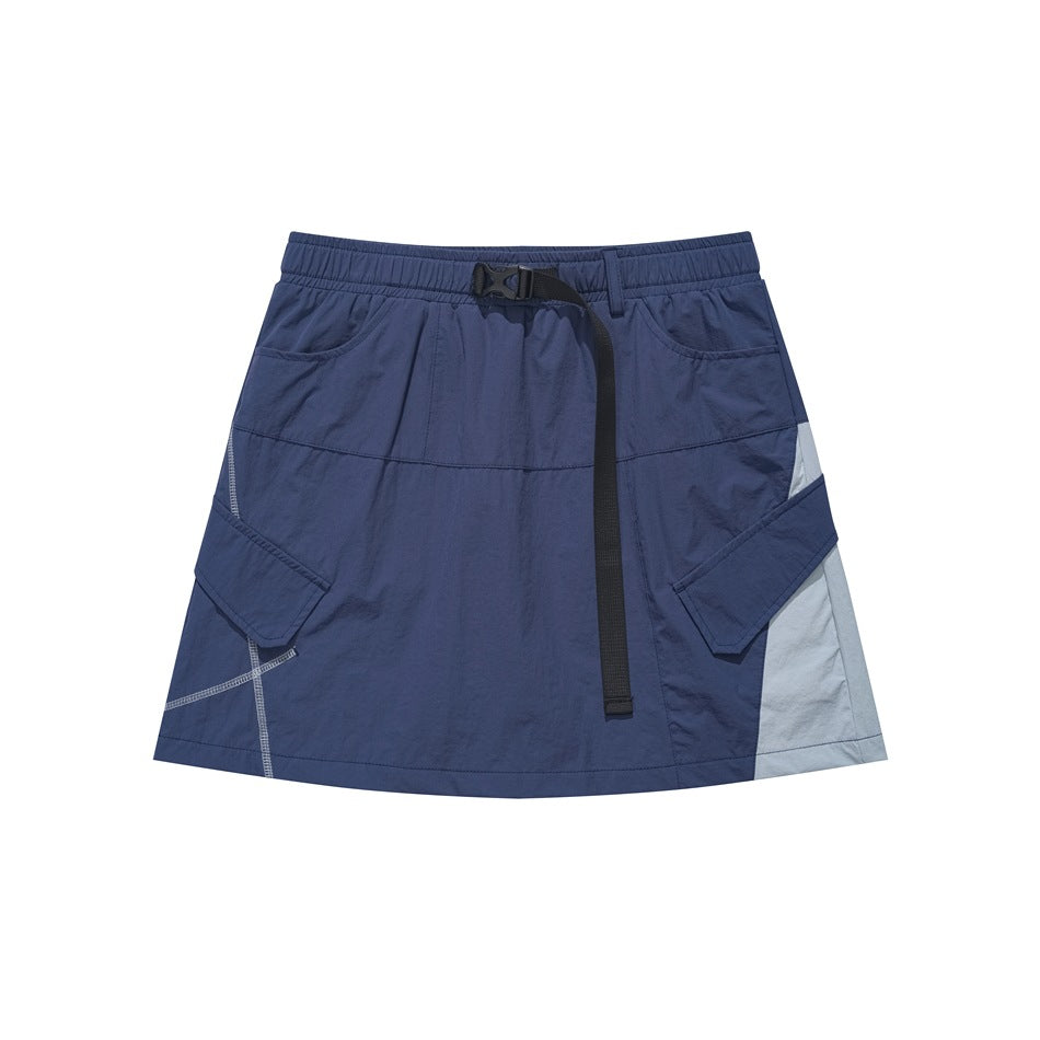 Navy mini cargo skirt with black buckle strap, flap pockets and light blue side panel