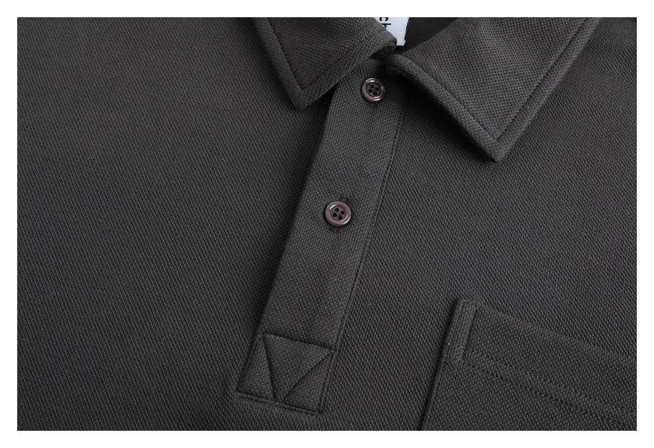 Close-up of the charcoal pullover's textured fabric, two-button placket, and reinforced placket end.