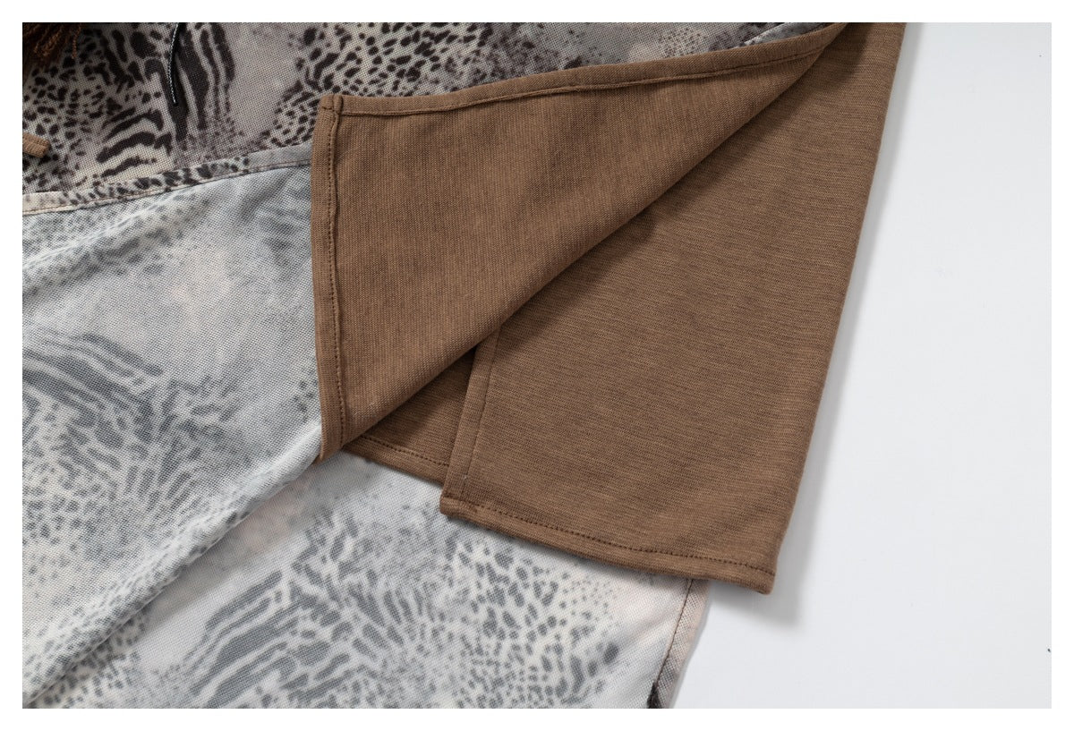 Close-up of a folded garment showing the animal-print outer fabric and plain brown inner side.