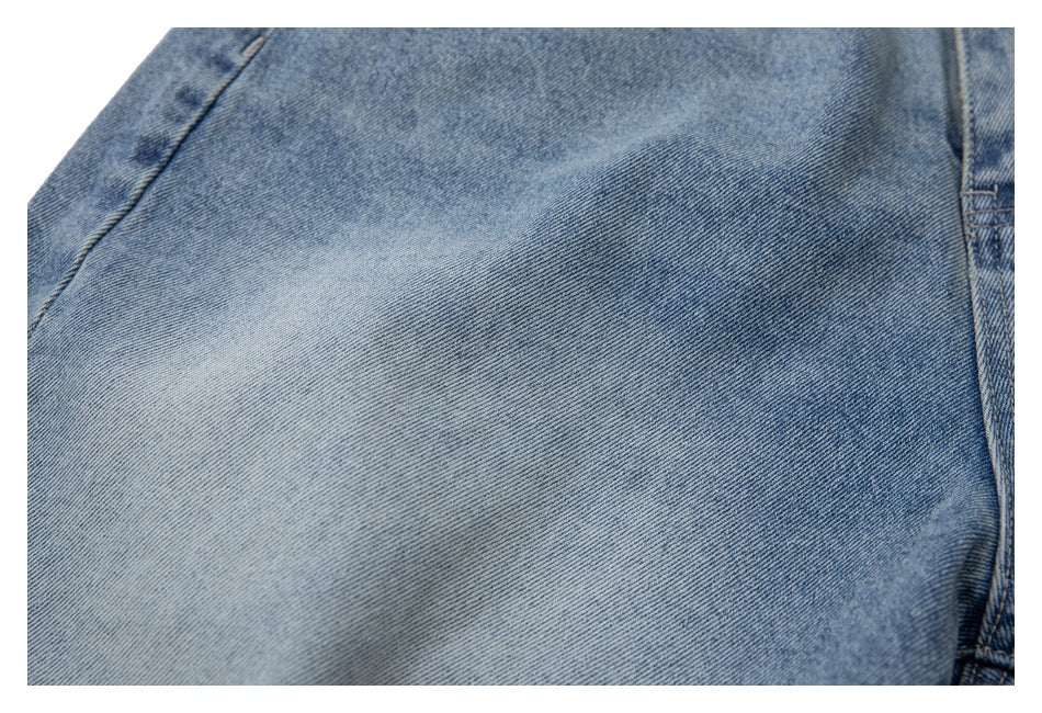 Close-up of the light blue denim fabric and fading on a jeans leg.