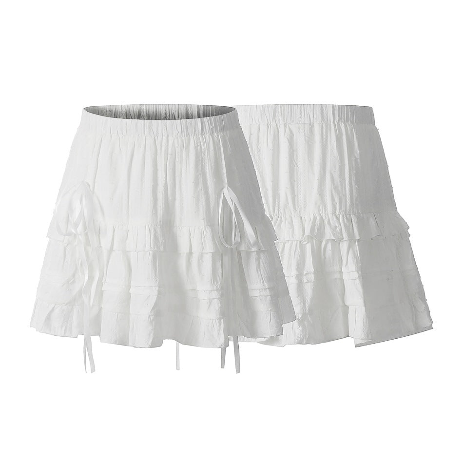 White tiered skirt shown from front and back, with a gathered waist and long side ties.