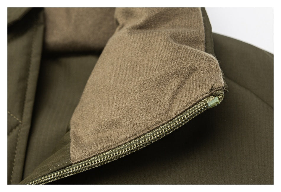 Close-up of an olive-brown garment showing a soft tan inner panel beside a sturdy zipper.