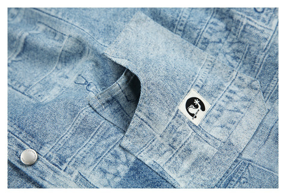 Close-up of a pocket opening and small black-and-white sewn patch on distressed light blue denim.