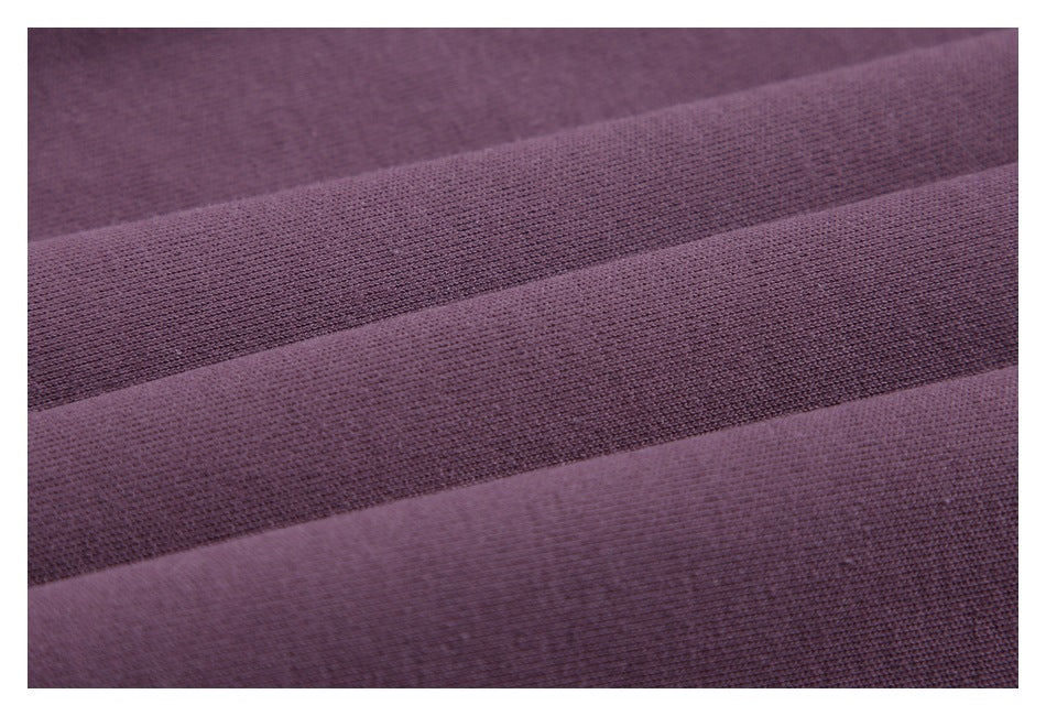 Macro view of the purple fabric's knit texture and folded layers.