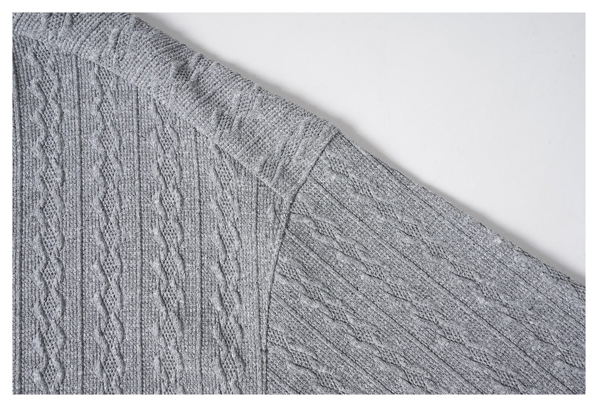 Close-up of the gray knit shirt's shoulder seam and sleeve construction.