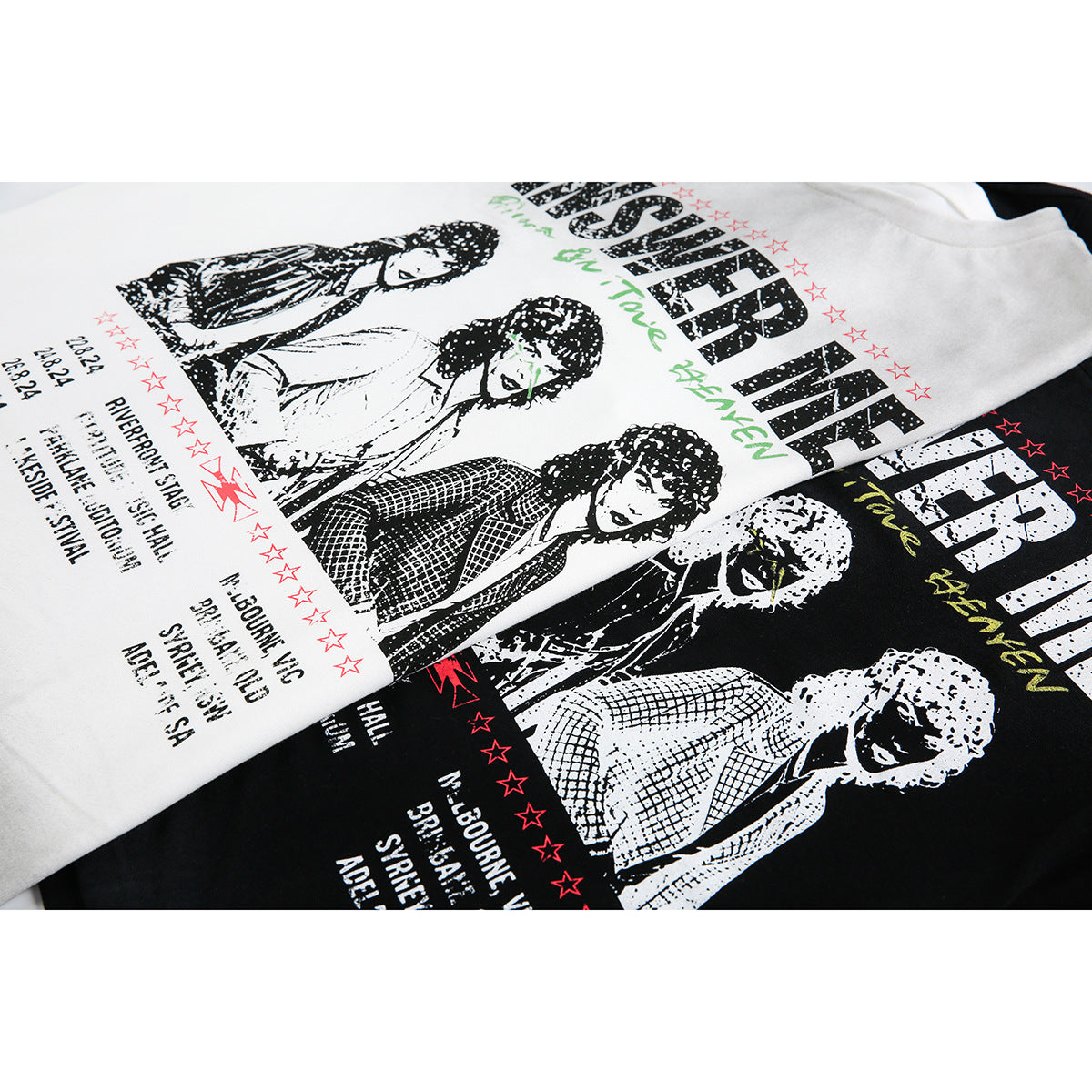 Close-up of white and black shirts with distressed band portraits, star motifs, and English tour-style lettering.