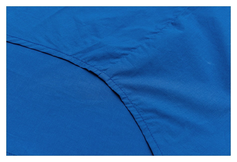 Close-up of a curved stitched seam on bright blue garment fabric.