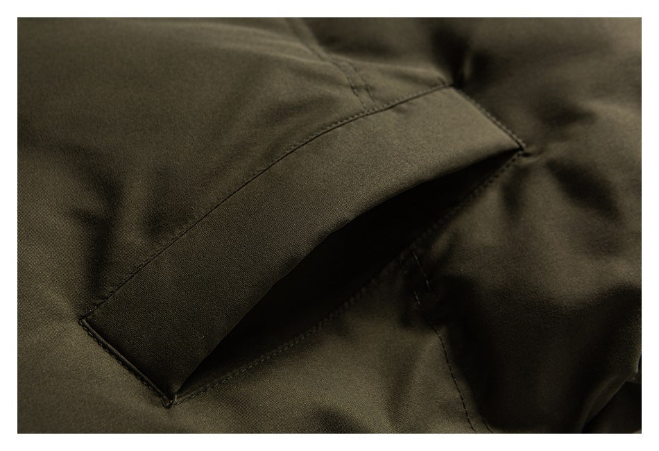 Close-up of the olive jacket's angled welt pocket and surrounding stitching.