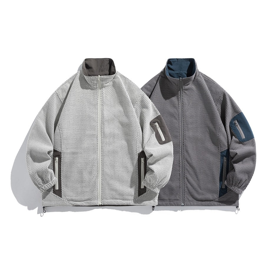 Two front-facing zip jackets: a light gray patterned version and a charcoal patterned version with contrasting panels.