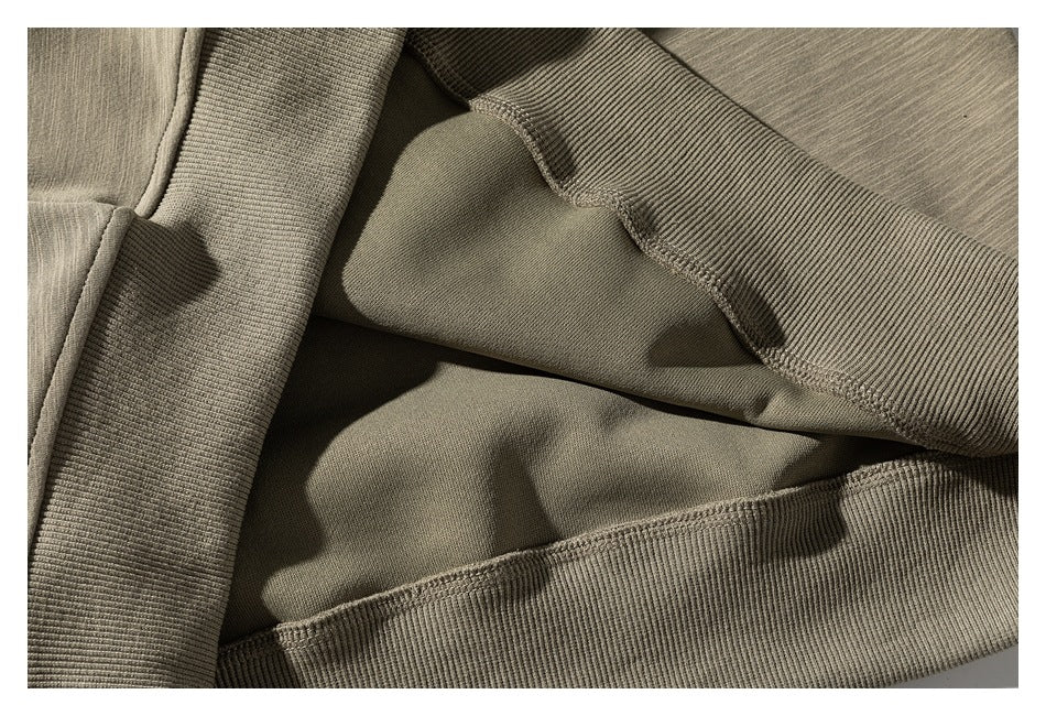 Close-up of the sweatshirt's ribbed trim, inner fabric, and stitched seams.
