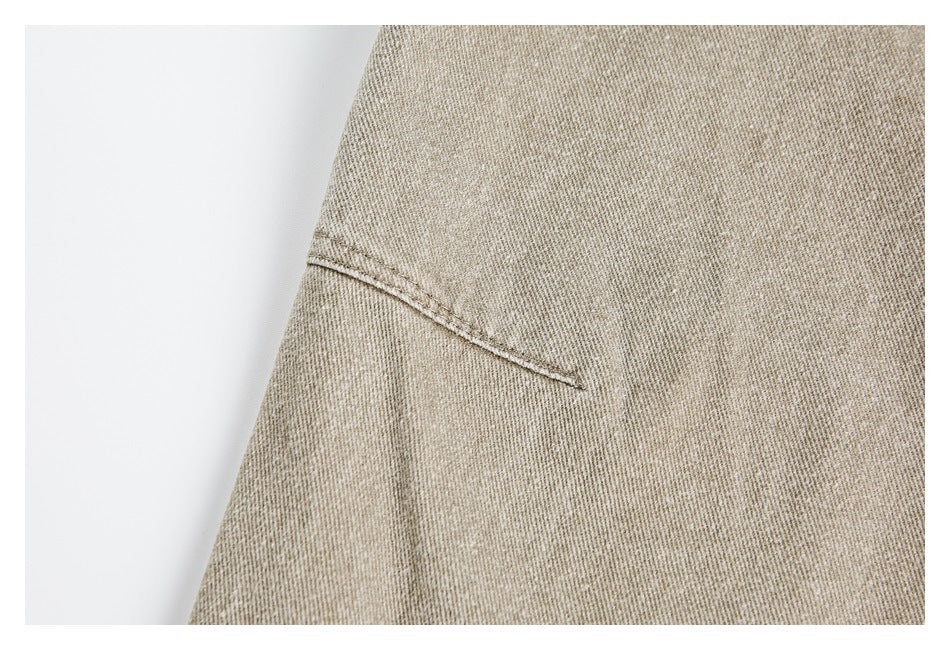 Close-up of beige fabric and a short stitched seam.