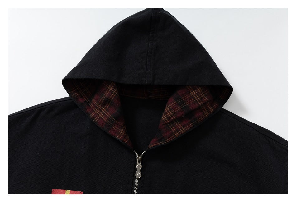 Close-up of the black jacket hood, showing burgundy plaid lining and the front zipper.