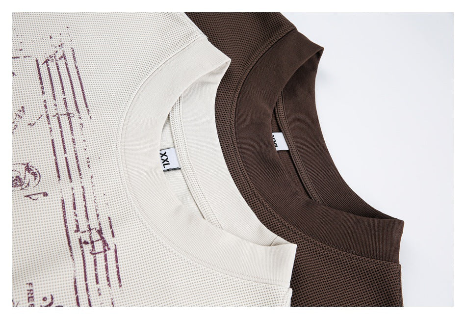 Close-up of off-white and dark brown T-shirt necklines, textured fabric, and visible XXL size label.