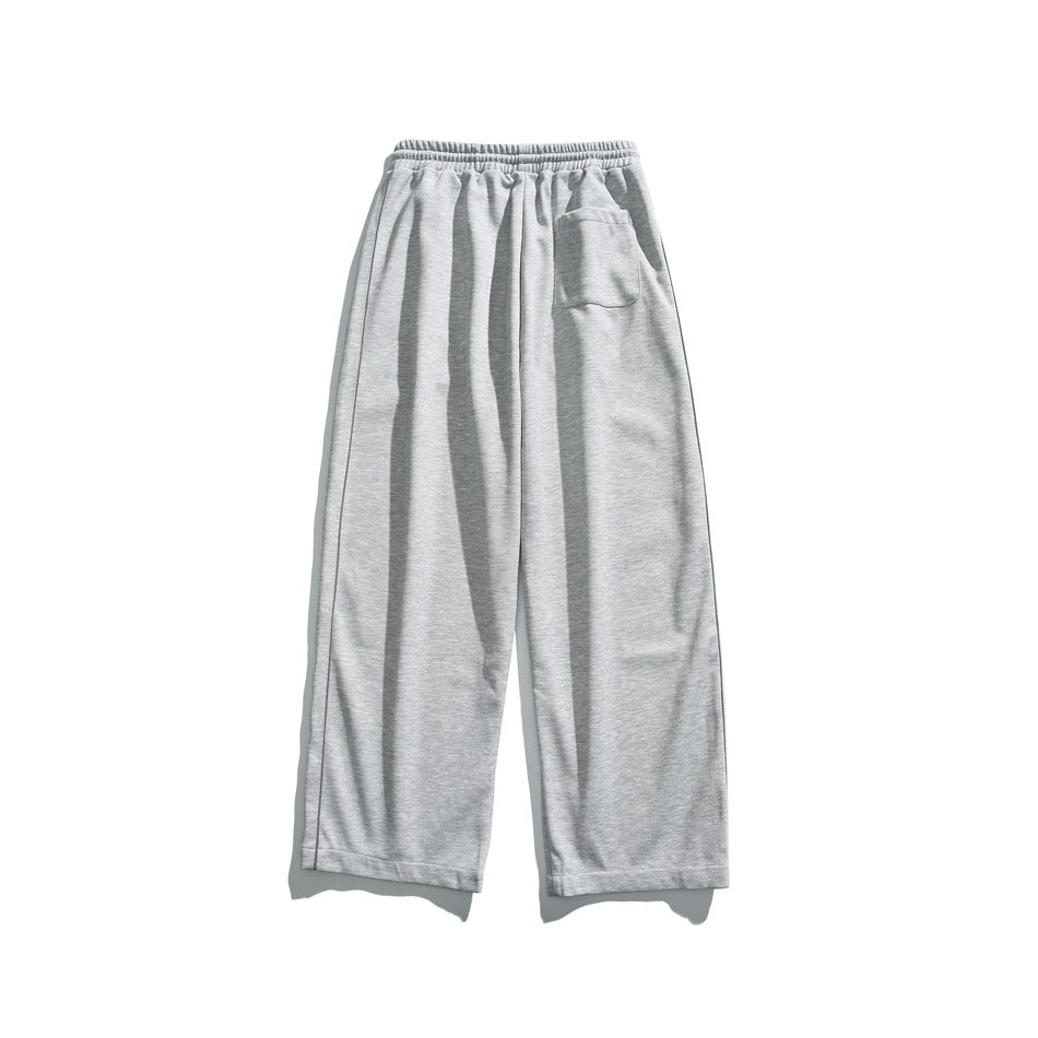 Light gray wide-leg pants with an elastic waistband and a small patch pocket, shown flat against white.