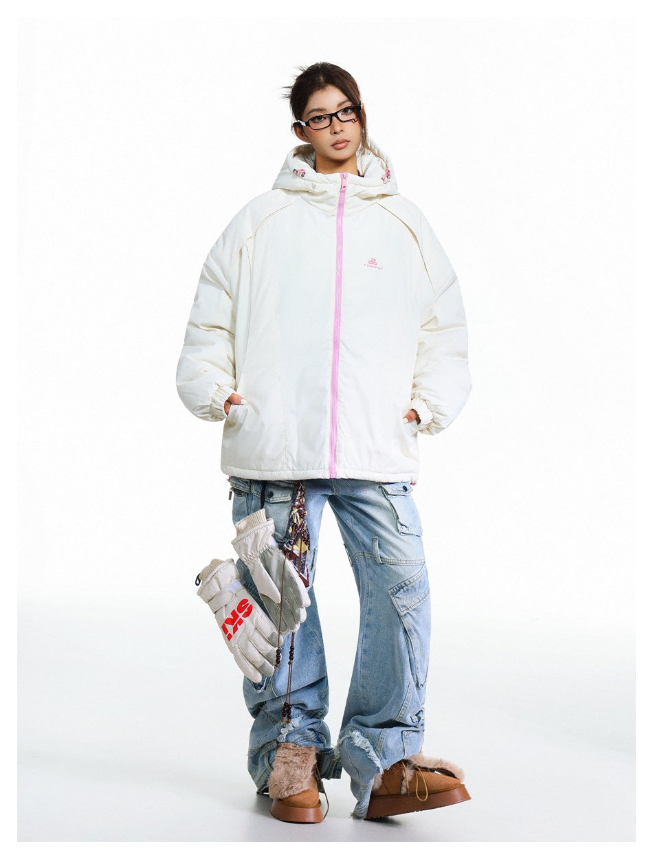 Model wearing an off-white hooded jacket with a pink zipper, paired with loose blue cargo jeans.