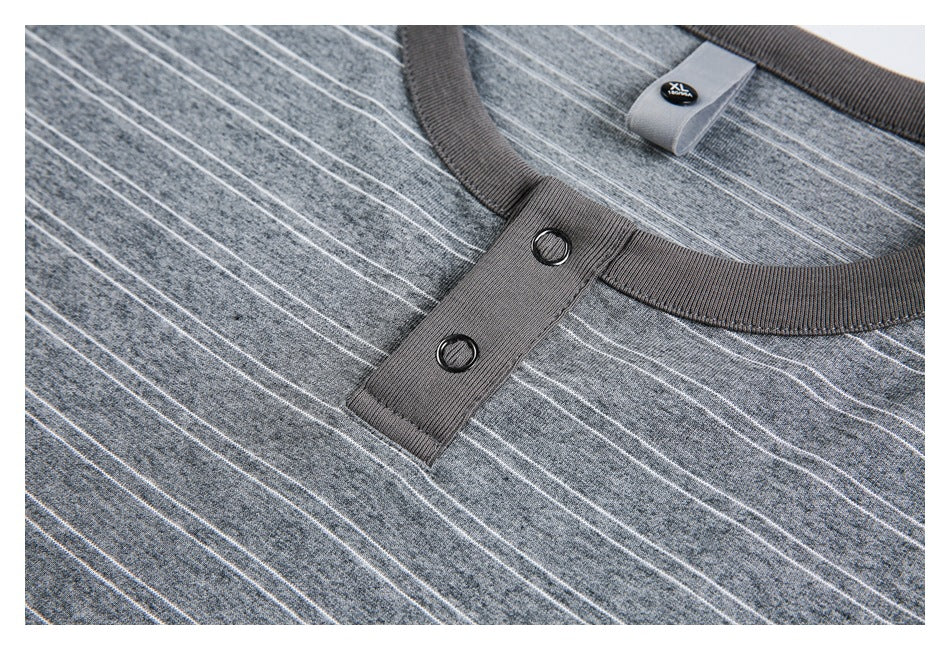 Close-up of the gray striped top's ribbed neckline and two dark buttons.